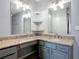 Stylish bathroom featuring granite countertops, dual mirrors, and modern lighting fixtures at 185 Poinciana Ln, Deltona, FL 32738
