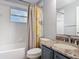 The bathroom includes a shower/tub combo, granite vanity, and a decorative floral shower curtain at 185 Poinciana Ln, Deltona, FL 32738