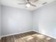 Bedroom featuring wood-look floors, ceiling fan, and electrical outlets at 185 Poinciana Ln, Deltona, FL 32738