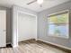 Cozy bedroom featuring a window with backyard view and closet with hanging bar at 185 Poinciana Ln, Deltona, FL 32738