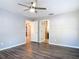 Spacious bedroom features a ceiling fan and two entryways to adjoining rooms at 185 Poinciana Ln, Deltona, FL 32738