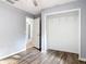 Bedroom with wood floors, closet, and doorway to hallway or bathroom at 185 Poinciana Ln, Deltona, FL 32738