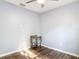 Minimalist bedroom featuring wood-look floors and a small gold table at 185 Poinciana Ln, Deltona, FL 32738