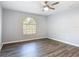 Bright bedroom with a ceiling fan, hardwood floors, and a window at 185 Poinciana Ln, Deltona, FL 32738