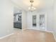Dining area with stylish chandelier, tiled flooring, and French doors leading to the outdoor living space at 185 Poinciana Ln, Deltona, FL 32738