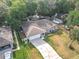 Charming single-story home featuring a two-car garage and landscaping at 185 Poinciana Ln, Deltona, FL 32738