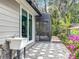 Exterior view of the home's side, showcasing a sink, screen door and access to the backyard at 185 Poinciana Ln, Deltona, FL 32738