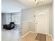Inviting foyer with tiled floors, a white front door, and a view of the living room at 185 Poinciana Ln, Deltona, FL 32738