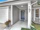 Close-up of a home's front entrance with blue door, white trim, and house number at 185 Poinciana Ln, Deltona, FL 32738