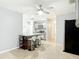 Open-concept kitchen features stainless steel fridge, breakfast bar, gray cabinetry, and modern appliances at 185 Poinciana Ln, Deltona, FL 32738