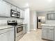 Spacious kitchen with granite countertops, stainless steel appliances, and ample cabinet space at 185 Poinciana Ln, Deltona, FL 32738