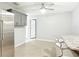 Spacious kitchen features stainless steel refrigerator, barstool seating, and gray cabinetry at 185 Poinciana Ln, Deltona, FL 32738