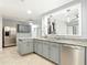 Modern kitchen featuring granite countertops, stainless steel appliances, and a window overlooking the living area at 185 Poinciana Ln, Deltona, FL 32738