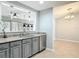 Modern kitchen featuring gray cabinetry, stainless steel appliances, and a window overlooking the living area at 185 Poinciana Ln, Deltona, FL 32738