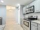 Stylish kitchen with granite countertops, stainless steel appliances, and an adjacent dining area at 185 Poinciana Ln, Deltona, FL 32738