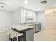 Bright kitchen with granite countertops, modern cabinetry, stainless steel appliances, and barstool seating at 185 Poinciana Ln, Deltona, FL 32738