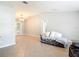 Bright living room featuring neutral paint, tile flooring, vaulted ceilings, and a comfortable chaise lounge at 185 Poinciana Ln, Deltona, FL 32738