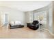 Living room featuring tiled floors, two large windows, and comfortable seating at 185 Poinciana Ln, Deltona, FL 32738