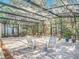 Spacious screened patio featuring brick flooring, comfortable seating, and a view of the lush backyard at 185 Poinciana Ln, Deltona, FL 32738