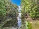 Picturesque canal view with lush greenery and clear blue sky reflecting in the water at 185 Poinciana Ln, Deltona, FL 32738