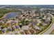 Panoramic aerial view of a residential area with a tranquil lake and well-maintained homes at 1862 Spreakley Ct, Orlando, FL 32837
