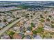Aerial view of a residential area with lush greenery, pools, and tree-lined streets near the highway at 1862 Spreakley Ct, Orlando, FL 32837