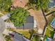 Aerial view of a home with a dark roof, a partially shaded yard, and a circular feature at 1862 Spreakley Ct, Orlando, FL 32837