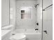 Modern bathroom with black fixtures, white tile, and bright lighting at 1862 Spreakley Ct, Orlando, FL 32837