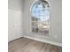 Bedroom with large arched window and closet doors with light grey walls at 1862 Spreakley Ct, Orlando, FL 32837