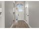 Bright foyer features hardwood floors, arched window, and a modern white door at 1862 Spreakley Ct, Orlando, FL 32837