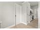 Hallway view leading to a kitchen with modern appliances and white cabinets at 1862 Spreakley Ct, Orlando, FL 32837
