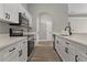 Modern kitchen features white cabinets, stainless steel appliances, and wood-look flooring at 1862 Spreakley Ct, Orlando, FL 32837