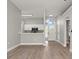 Open living room view of a bright foyer and a kitchen with white cabinets at 1862 Spreakley Ct, Orlando, FL 32837