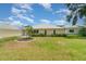 Well-maintained backyard featuring lush green grass and a quaint garden, adding to the home's charm at 21529 Prince Albert Ct, Leesburg, FL 34748