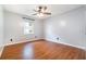 Bedroom with wood floors and a ceiling fan with integrated lighting, with a neutral wall color at 21529 Prince Albert Ct, Leesburg, FL 34748
