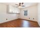 Bedroom with wood floors and a ceiling fan with integrated lighting and a built-in cabinet at 21529 Prince Albert Ct, Leesburg, FL 34748