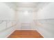 Walk-in closet with laminate wood floors and metal shelving for optimal storage and organization at 21529 Prince Albert Ct, Leesburg, FL 34748