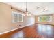 Dining room featuring hardwood floors, a modern chandelier and natural lighting at 21529 Prince Albert Ct, Leesburg, FL 34748