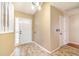Bright entryway featuring a decorative front door and neutral wall colors at 21529 Prince Albert Ct, Leesburg, FL 34748
