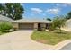 Charming single-story home featuring a well-maintained lawn and a two-car garage at 21529 Prince Albert Ct, Leesburg, FL 34748