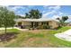 Well maintained lawn with shrubbery and mulch around the home's foundation at 21529 Prince Albert Ct, Leesburg, FL 34748