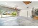 Spacious garage featuring ample storage, a clear glass garage door, and access to laundry and utilities at 21529 Prince Albert Ct, Leesburg, FL 34748