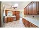 Spacious kitchen featuring wood cabinets, stainless appliances, and white counters with lots of storage at 21529 Prince Albert Ct, Leesburg, FL 34748