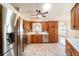 Bright kitchen featuring stainless appliances, lots of wood cabinets and drawers, and white counters at 21529 Prince Albert Ct, Leesburg, FL 34748