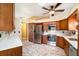Bright kitchen with stainless appliances, white counters, and wood cabinets with a stainless wine rack at 21529 Prince Albert Ct, Leesburg, FL 34748
