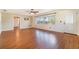 Bright living room featuring hardwood floors, a ceiling fan, and natural lighting at 21529 Prince Albert Ct, Leesburg, FL 34748