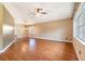 Spacious living room with hardwood floors, a ceiling fan, and bright natural light at 21529 Prince Albert Ct, Leesburg, FL 34748