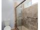 Bathroom with tiled shower and glass door at 235 Hollingshead Loop, Davenport, FL 33896