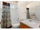 Well-lit bathroom with a shower-tub combination, white tile, and vanity at 235 Hollingshead Loop, Davenport, FL 33896