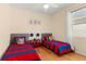 Bright bedroom featuring two beds, wood floors, and nautical-themed decor creating a playful atmosphere at 235 Hollingshead Loop, Davenport, FL 33896